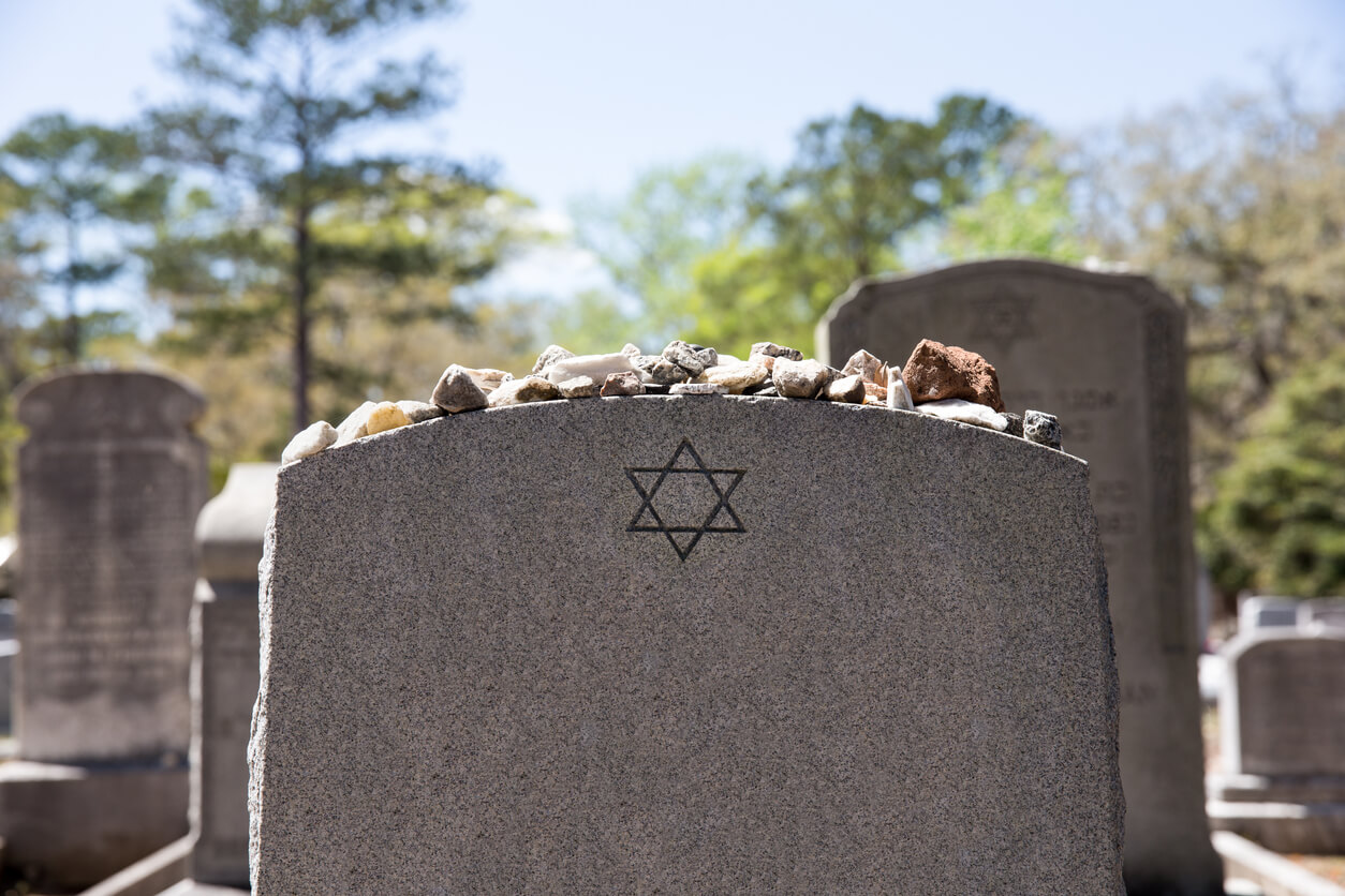 Jews have a custom to put rocks on top of gravestones.