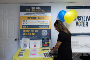 A woman takes a sticker at a Jewish Get Out The Vote center opened by Pennsylvania Unites in Merion Station, Pennsylvania, on Sept. 17.