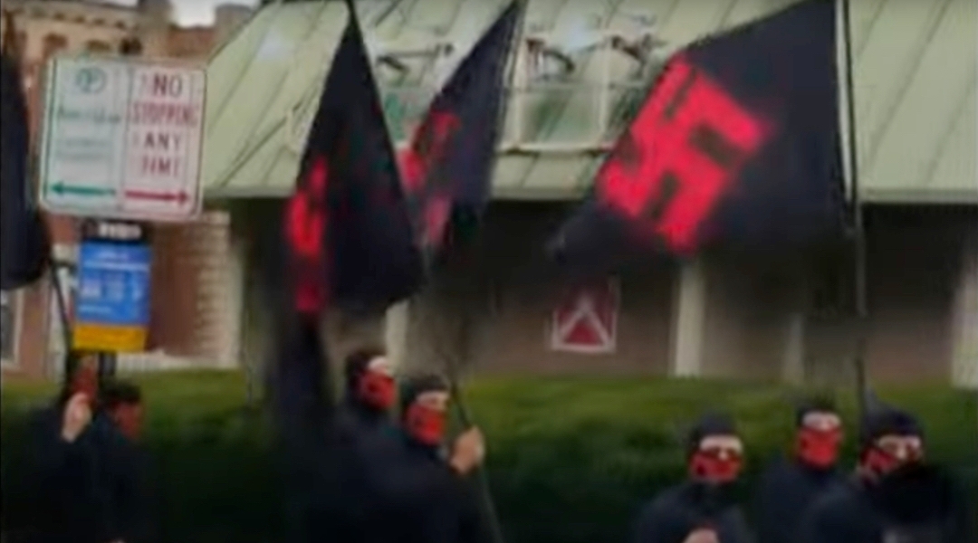 A group of neo-Nazis marched through downtown Columbus, Ohio, waving swastika flags and displaying antisemitic language, Nov. 16, 2024. (Screenshot via CBS News)