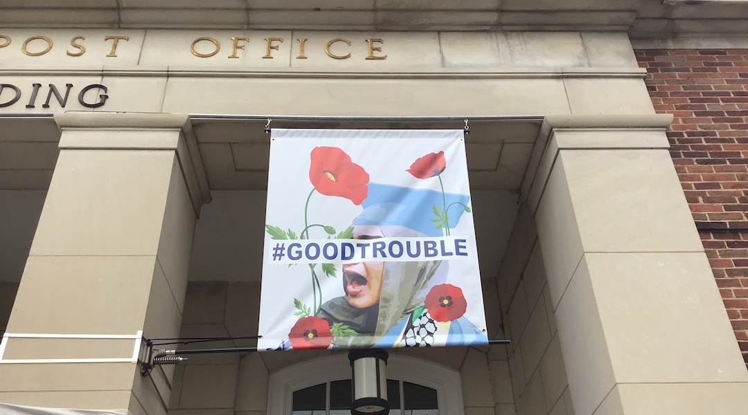 A banner depicting a university graduate in a keffiyeh in Chapel Hill, North Carolina, installed by the city in tribute to its civil rights legacy, Nov. 19, 2024. After pushback from Jewish groups, the city removed the banner the next day. (Jane Gabin/JTA)