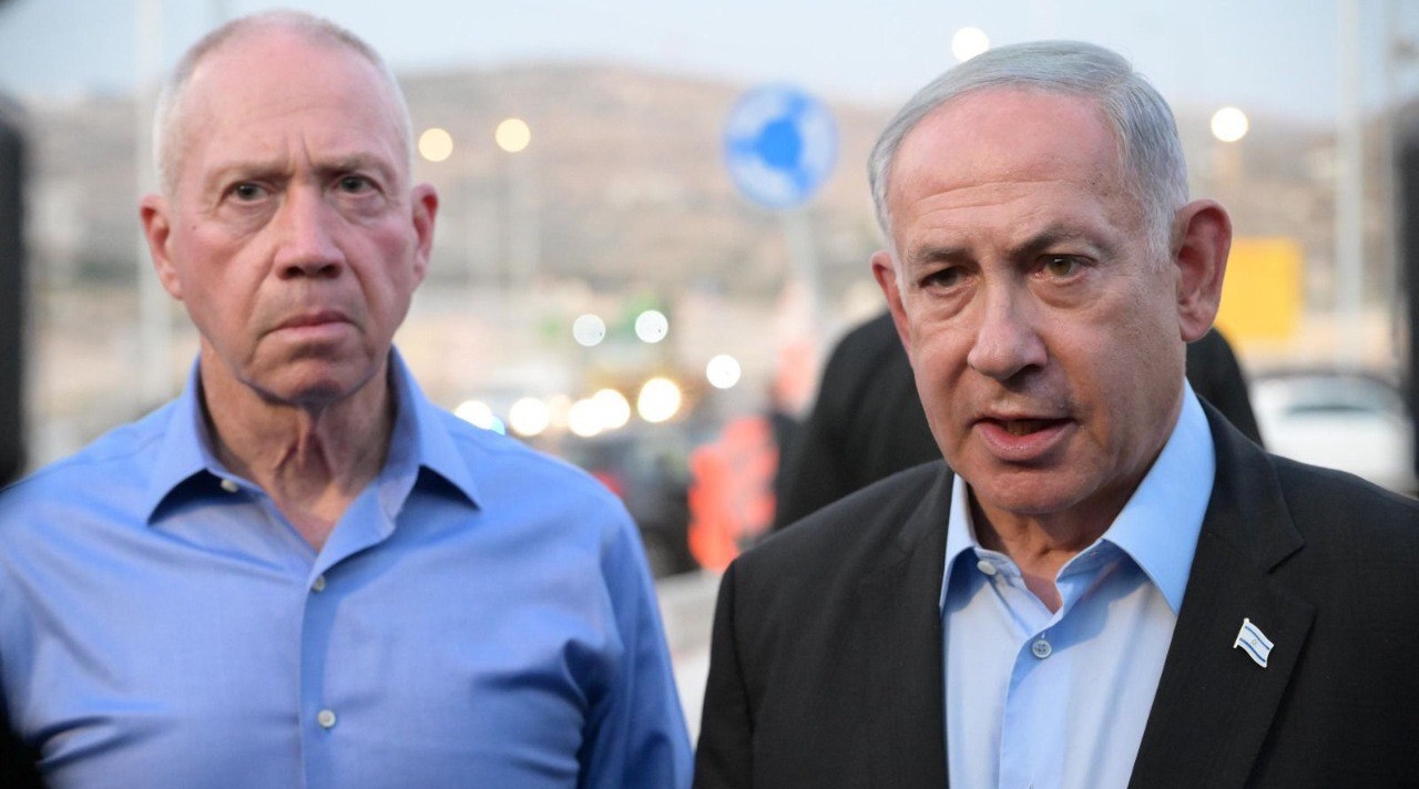 Israeli Prime Minister Benjamin Netanyahu, right, and then Israeli Defense Minister Yoav Gallant visit the site of the shooting where a settler was killed and another seriously injured in Hebron, Aug. 21, 2023. (Amos Ben-Gershom (GPO) / Handout/Anadolu Agency via Getty Images)