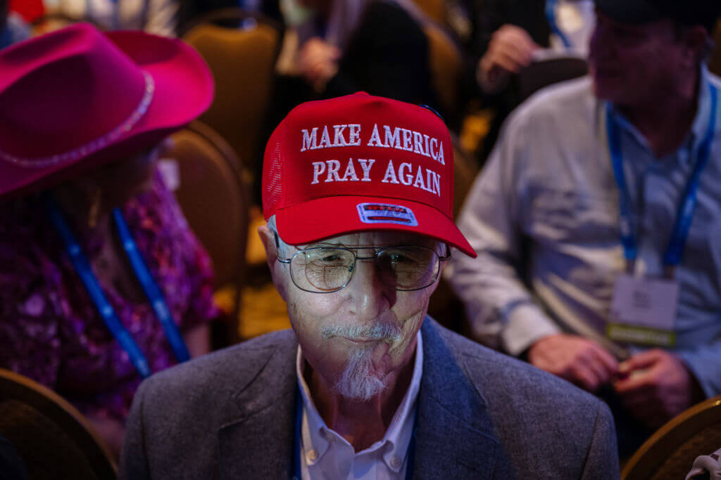 An attendee at a Christian conference in Nashville where Donald Trump was speaking wears a "Make America Pray Again" hat in February 2024.