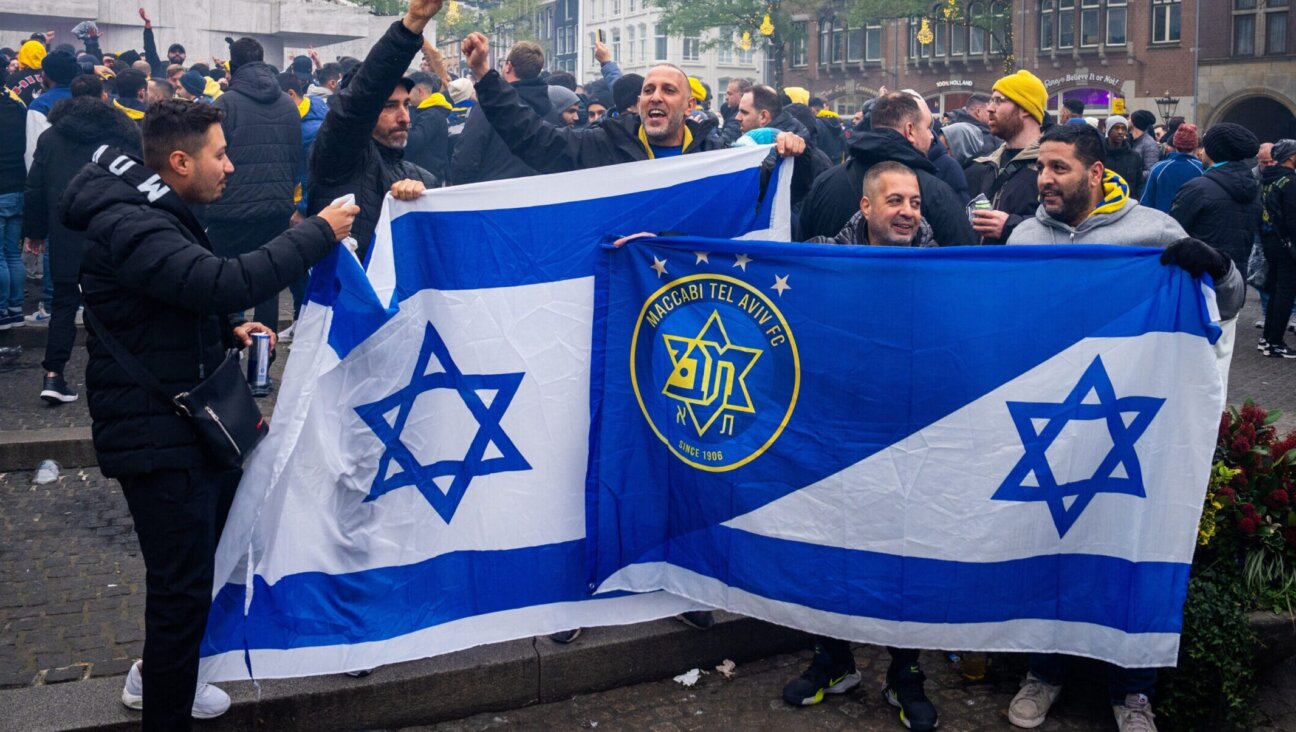 Supporters of Maccabi Tel Aviv hold Israeli and team flags at Dam Square ahead of the Europa League football match between Ajax and Maccabi Tel Aviv Nov. 7.