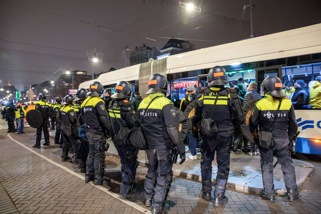 Dutch police officers stand guard after violence broke out in Amsterdam after a soccer match between Ajax Amsterdam and Maccabi Tel Aviv.