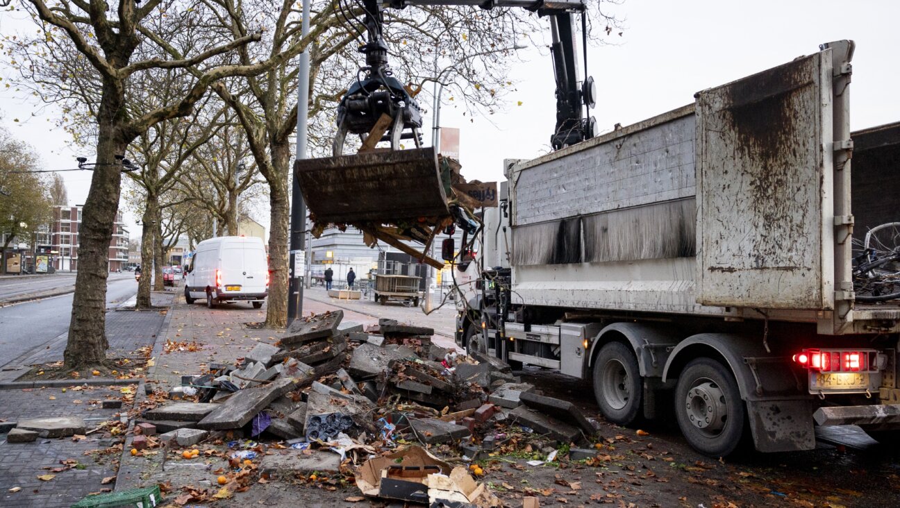 Debris is removed from the street following overnight riots in Amsterdam.