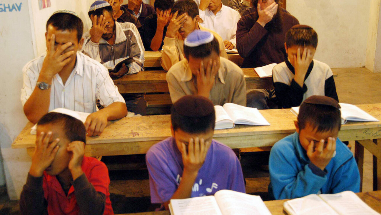 Jews place their hands to their faces in prayer.