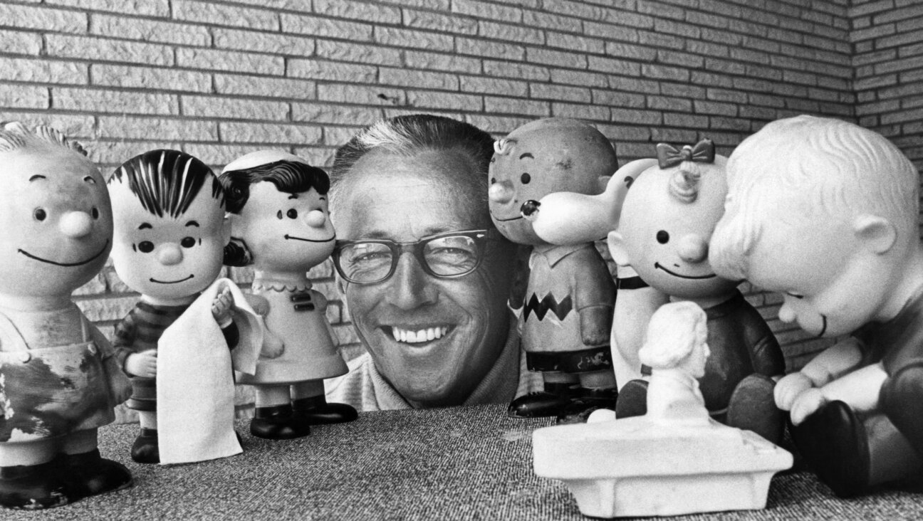 Charles Schultz surrounded by rubber doll replicas of the characters in his <i>Peanuts</i> comic strip in 1966.