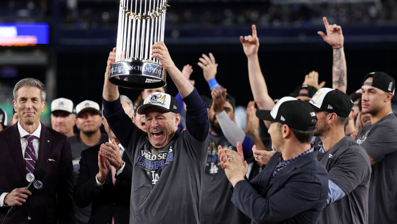 Stan Kasten, president and CEO of the Los Angeles Dodgers, celebrates with the Commissioner’s Trophy after defeating the New York Yankees in the 2024 World Series, Oct. 30, 2024, in New York City. (Elsa/Getty Images)