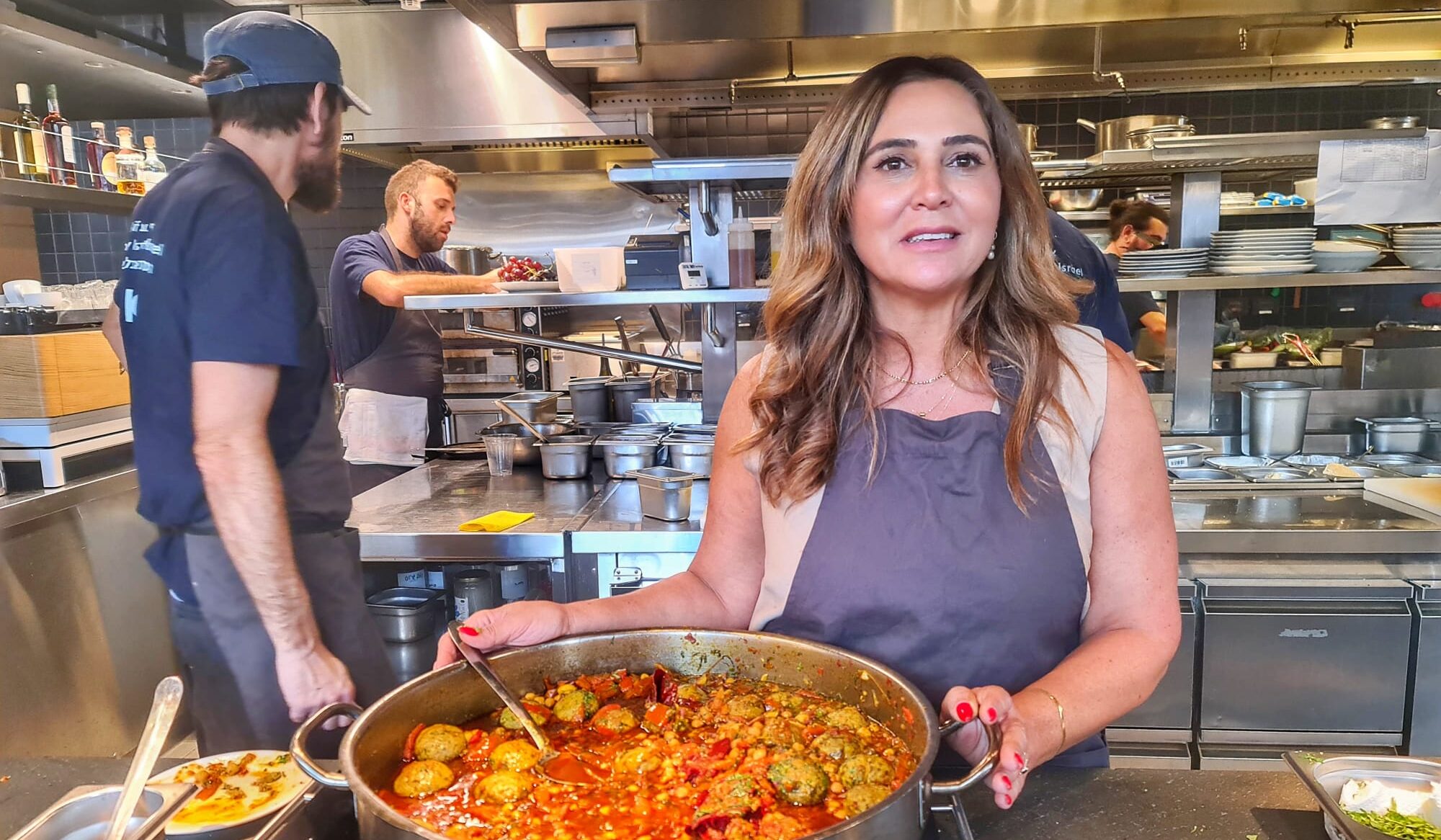 Sharona Dahan cooks at Asif in Tel Aviv, in a rare respite from takeout nearly a year after being evacuated from her home in Sderot, October 2024. (Deborah Danan)