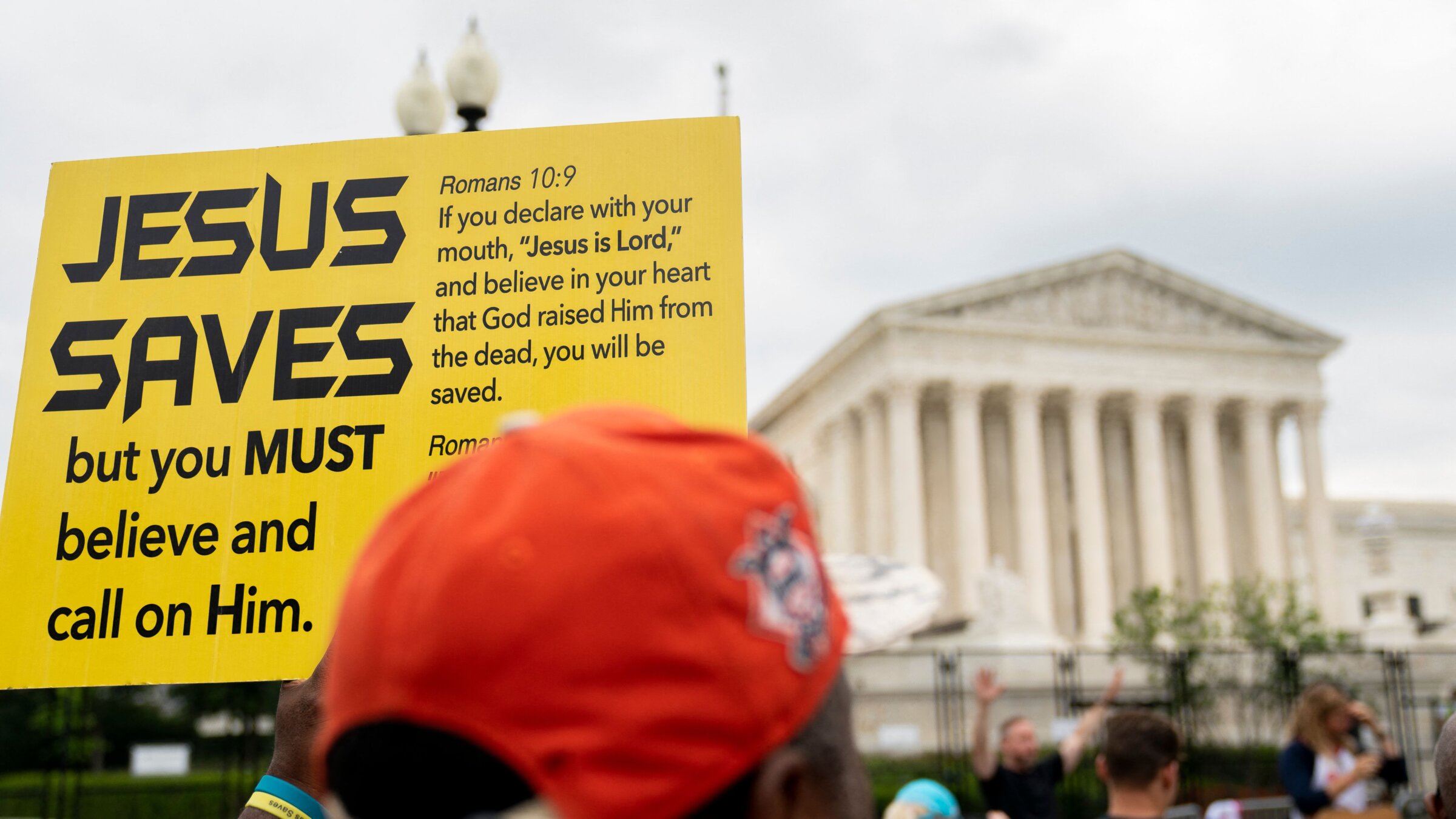 A person holds a Jesus Saves sign outside the U.S. Supreme Court on June 27, 2022.