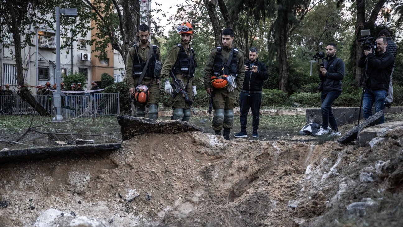 Israeli civil defense members investigate damage after a missile launched from Yemen hits residential neighborhood in Tel Aviv, Dec. 21, 2024. (Mostafa Alkharouf/Anadolu via Getty Images)