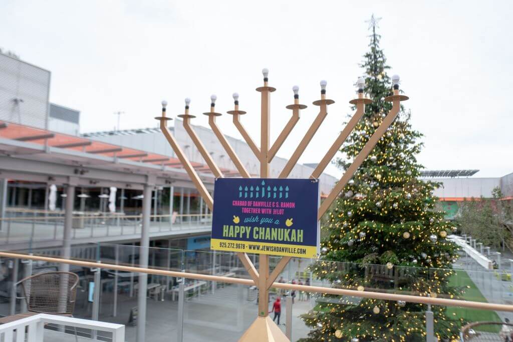 A Hanukkah menorah and a Christmas tree at a shopping center in San Ramon, California.