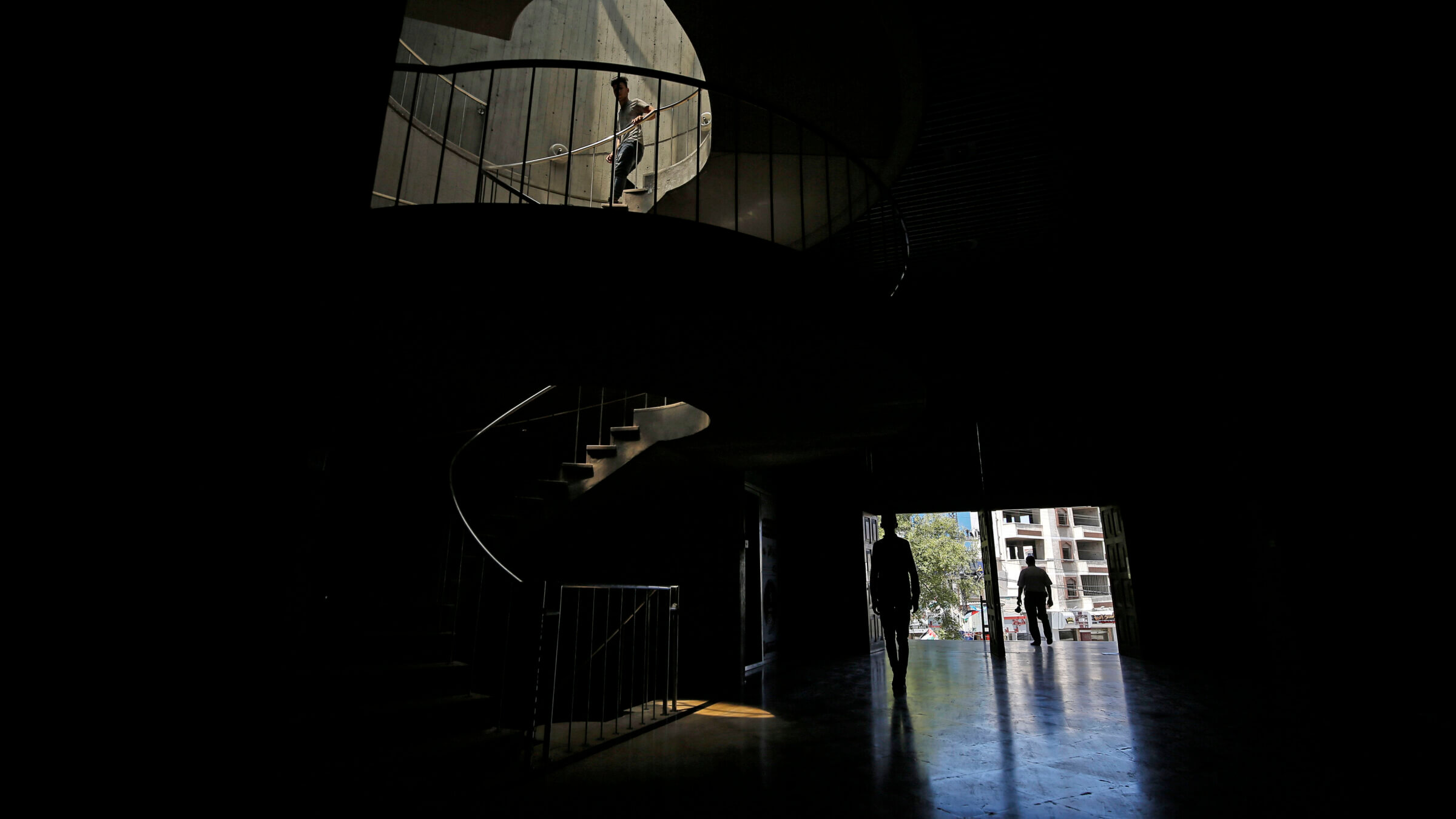 Palestinians walk at the Rashad al-Shawa Cultural Centre, a famous cultural institution in Gaza City, in 2020. Israel destroyed the building during the current war in Gaza. "They’re bombing the city’s landmarks,” a municipal worker in Gaza City told Amnesty International. “Their intent is for the city to have a different face after the war.”