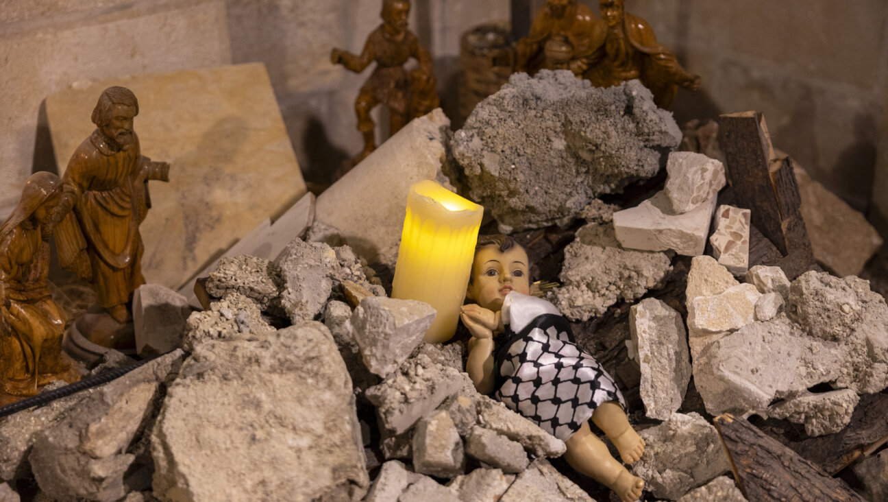 The Nativity scene shows baby Jesus wrapped in a keffiyeh and placed in a rubble to show solidarity with the people of Gaza on Dec. 24, 2023 in the Evangelical Lutheran Christmas Church in Bethlehem, West Bank. 