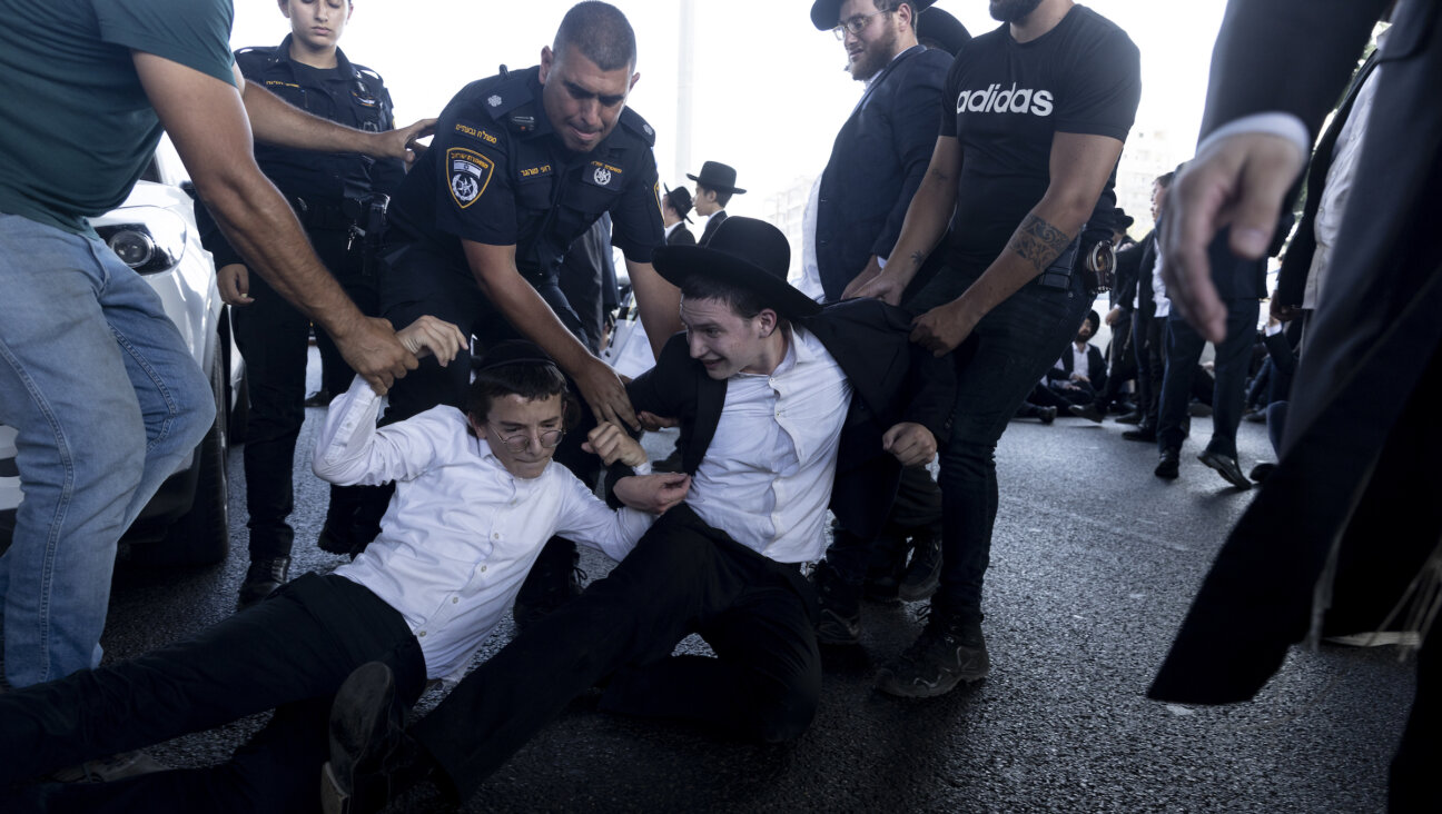 Israeli police officers arrest Haredi Jewish protesters demonstrating against the end of the Haredi draft exemption in July. 