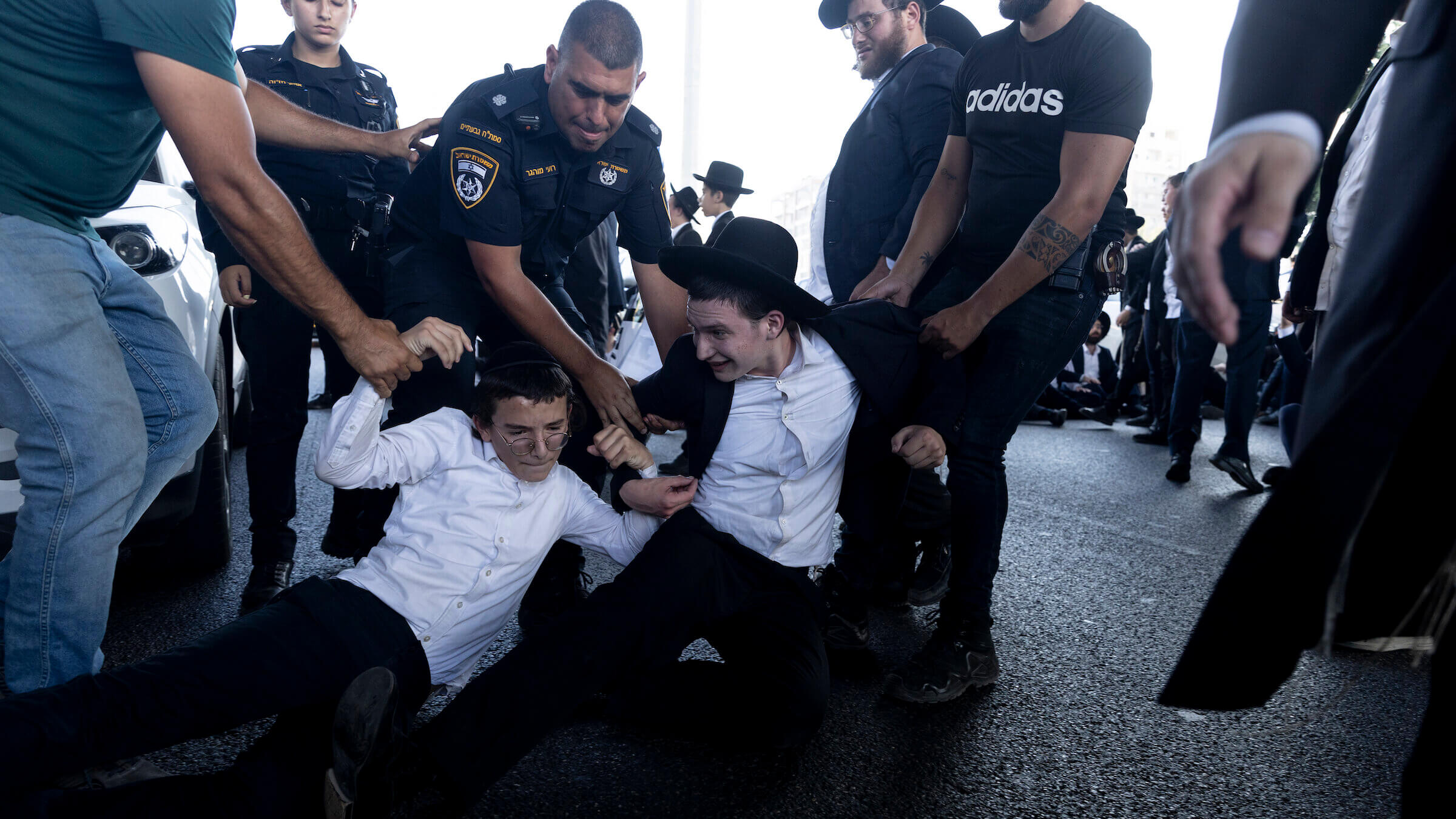 Israeli police officers arrest Haredi Jewish protesters demonstrating against the end of the Haredi draft exemption in July. 