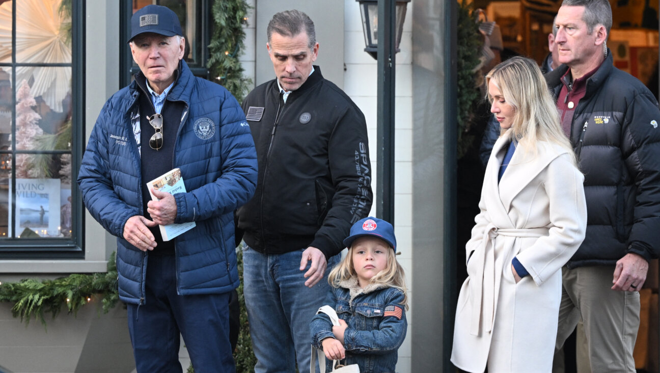 President Joe Biden walks out of Nantucket Bookworks with son Hunter Biden, grandson Beau and daughter-in-law Melissa Cohen Biden in Nantucket, Mass., on Nov. 29, 2024. Biden is holding the book "The Hundred Years' War on Palestine" by Rashid Khalidi. 