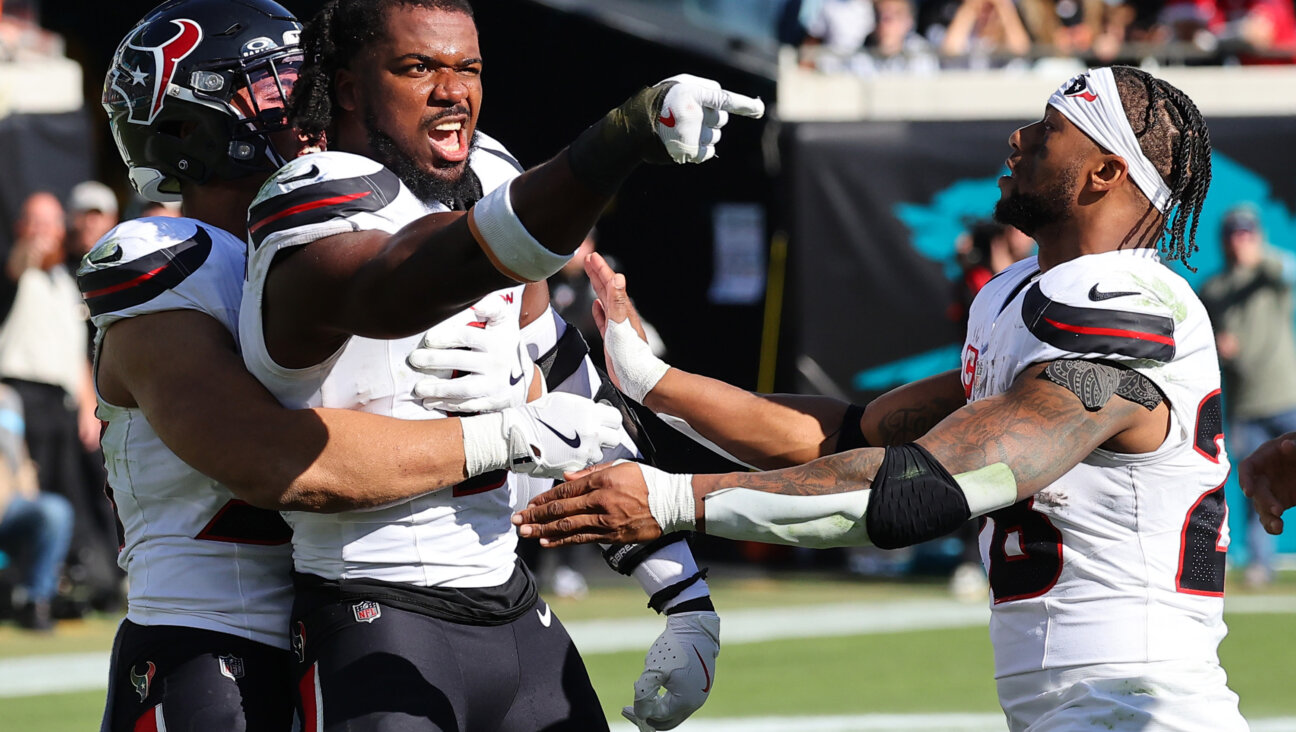 Azeez Al-Shaair points to the Jacksonville Jaguars bench after a fight following his hit on Trevor Lawrence Dec. 1.