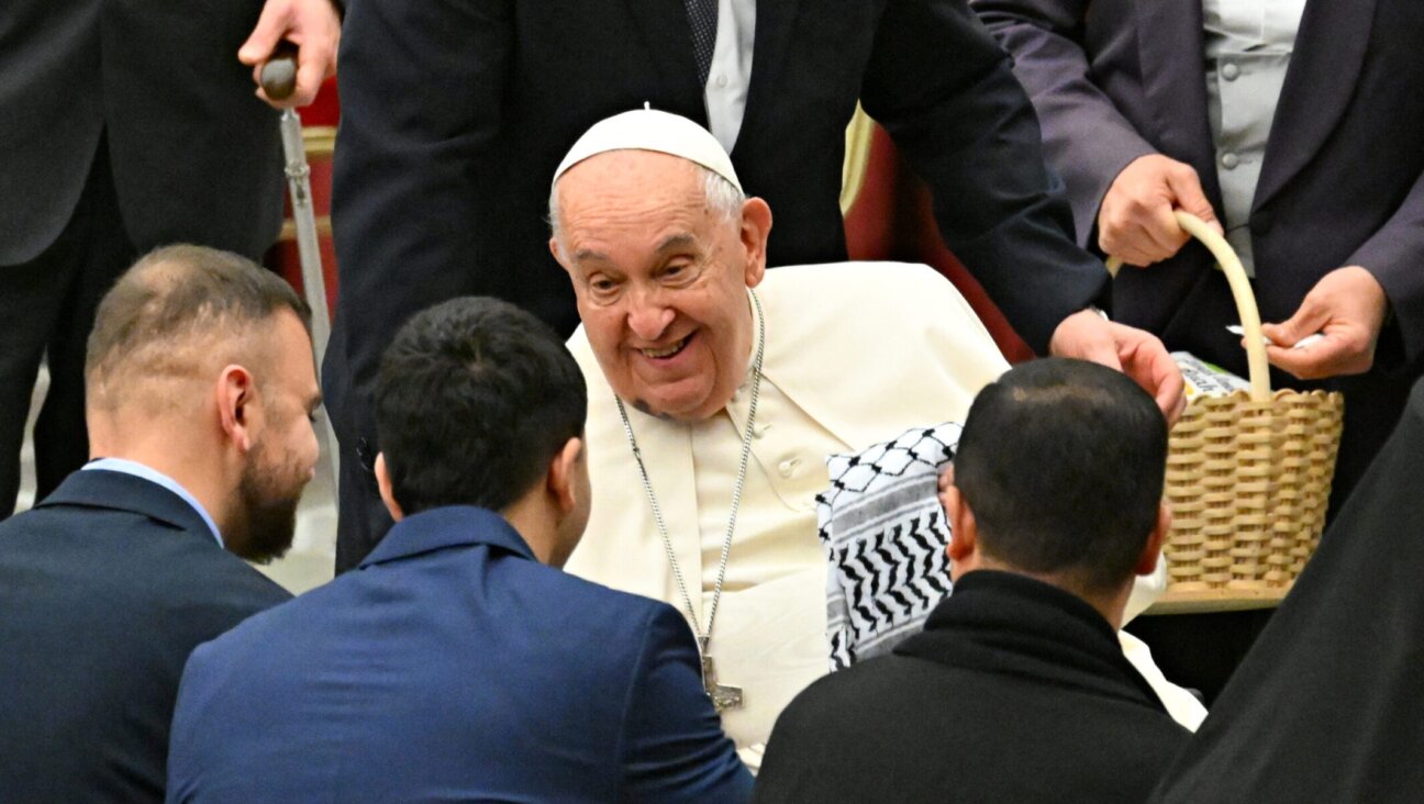 Members of the Palestinian embassy to the Holy See give a keffiyeh, a traditional Palestinian scarf, to Pope Francis during a Christmas ceremony at St Peter’s Square at the Vatican, Dec. 7, 2024. (Andreas Solaro/AFP via Getty Images)