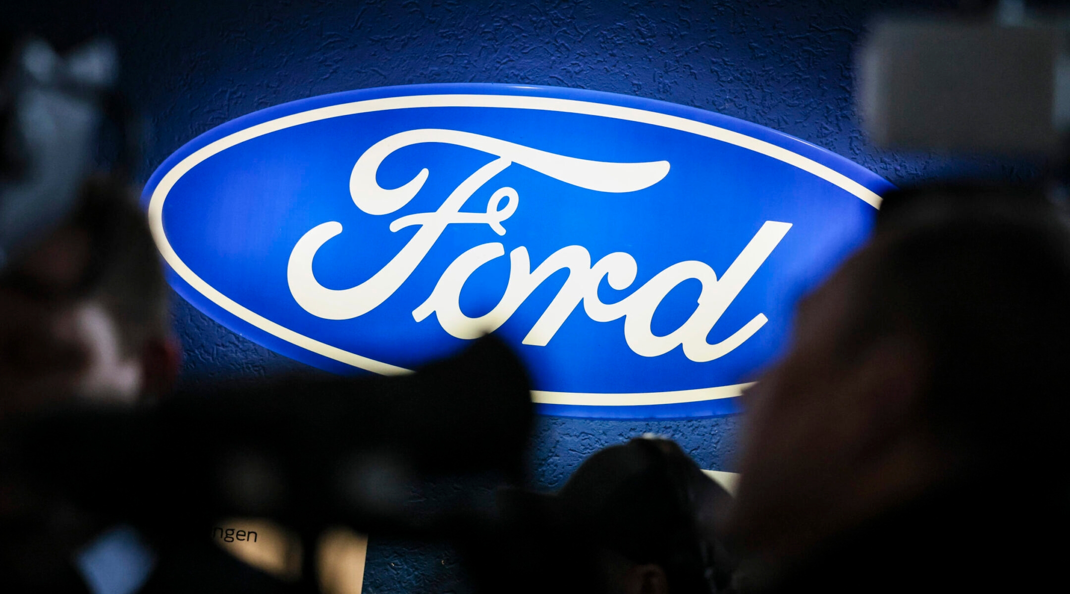 An illuminated Ford company sign shines on the sidelines of a works meeting at the company’s Germany site in Cologne, Dec. 10, 2024. (Christoph Reichwein/picture alliance via Getty Images)