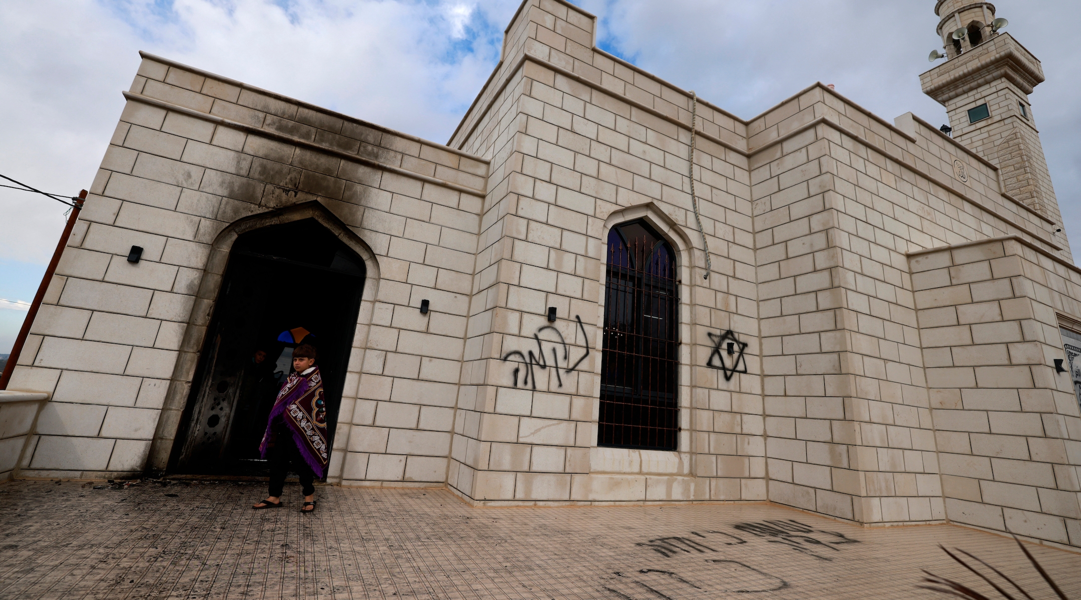 Palestinians inspect the damage done to a mosque after a reported attack by Israeli settlers in the West Bank town of Marda on Dec. 20, 2024. (Jaafar ASHTIYEH / AFP)