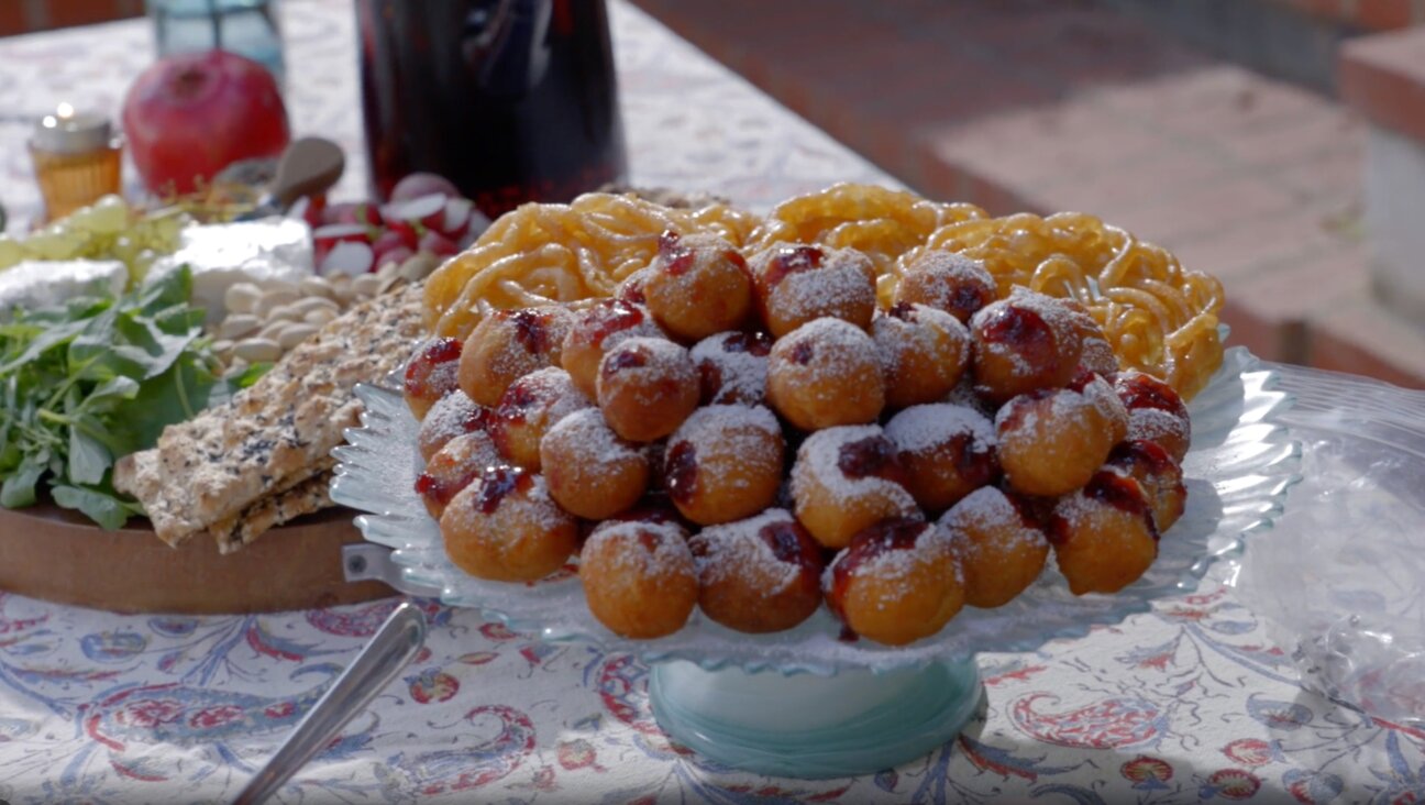 Sufganiyot filled with Iranian sour cherry jam and Iranian  zoulbia pastries adorn the Erev Yalda table.