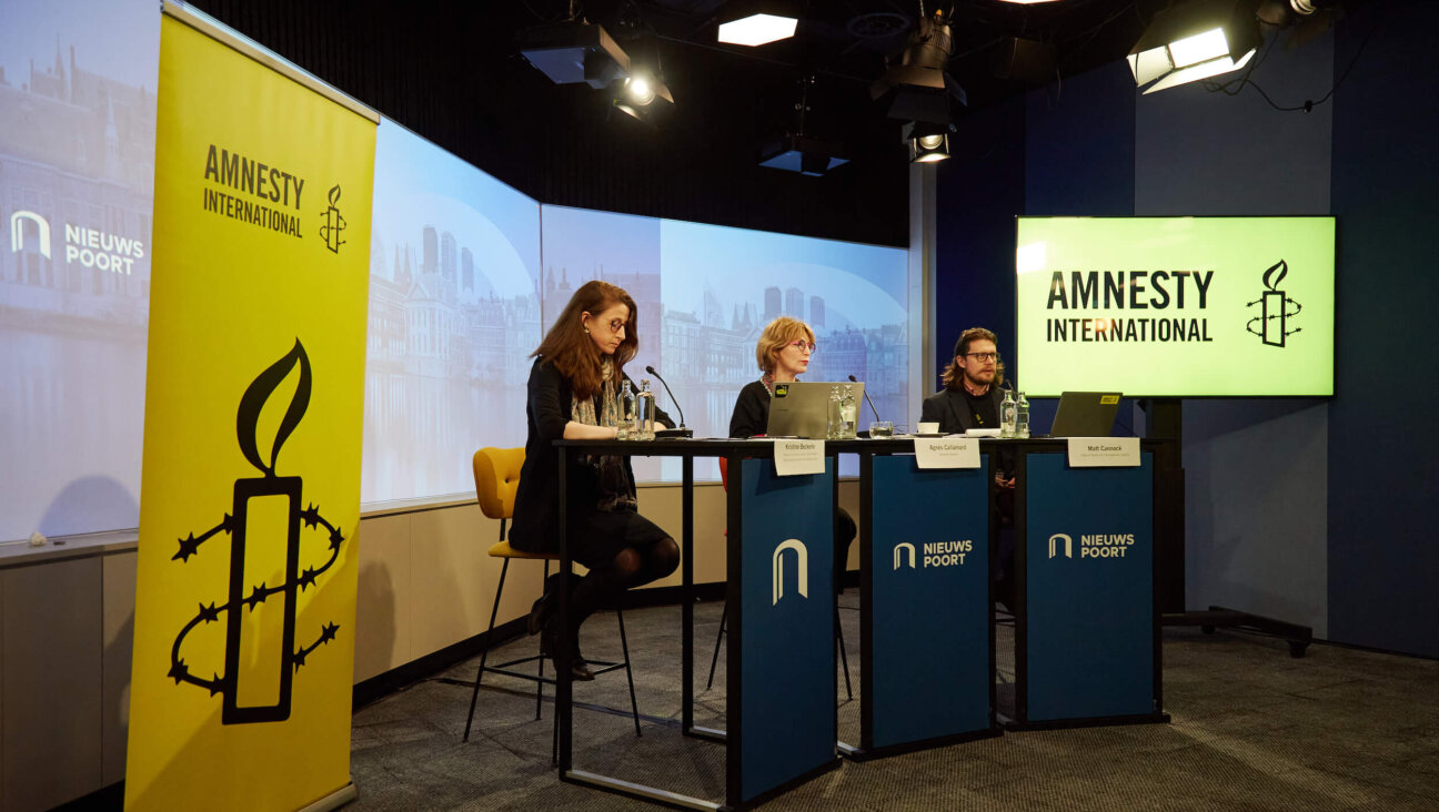 Amnesty International officers present the group's new report alleging genocide by Israel in Gaza on Dec. 4. 