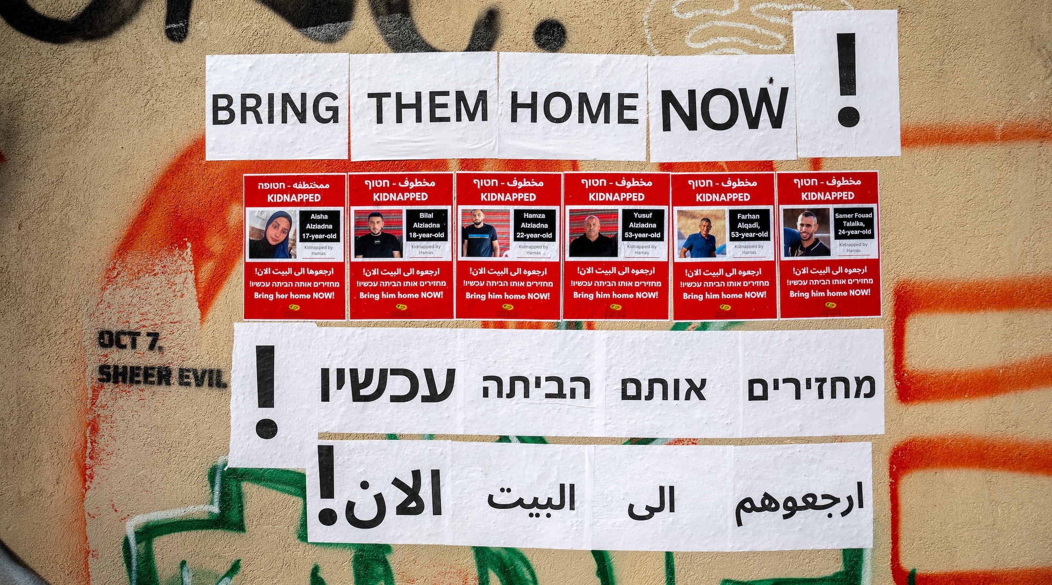 Posters calling for the return of four members of the Bedouin Ziadna family from Rahat who were kidnapped on Oct. 7, 2023, were written in Hebrew, English and Arabic and hung in the center of Tel Aviv, Nov. 30, 2023. (Yahel Gazit / Middle East Images / via AFP/Getty Images)