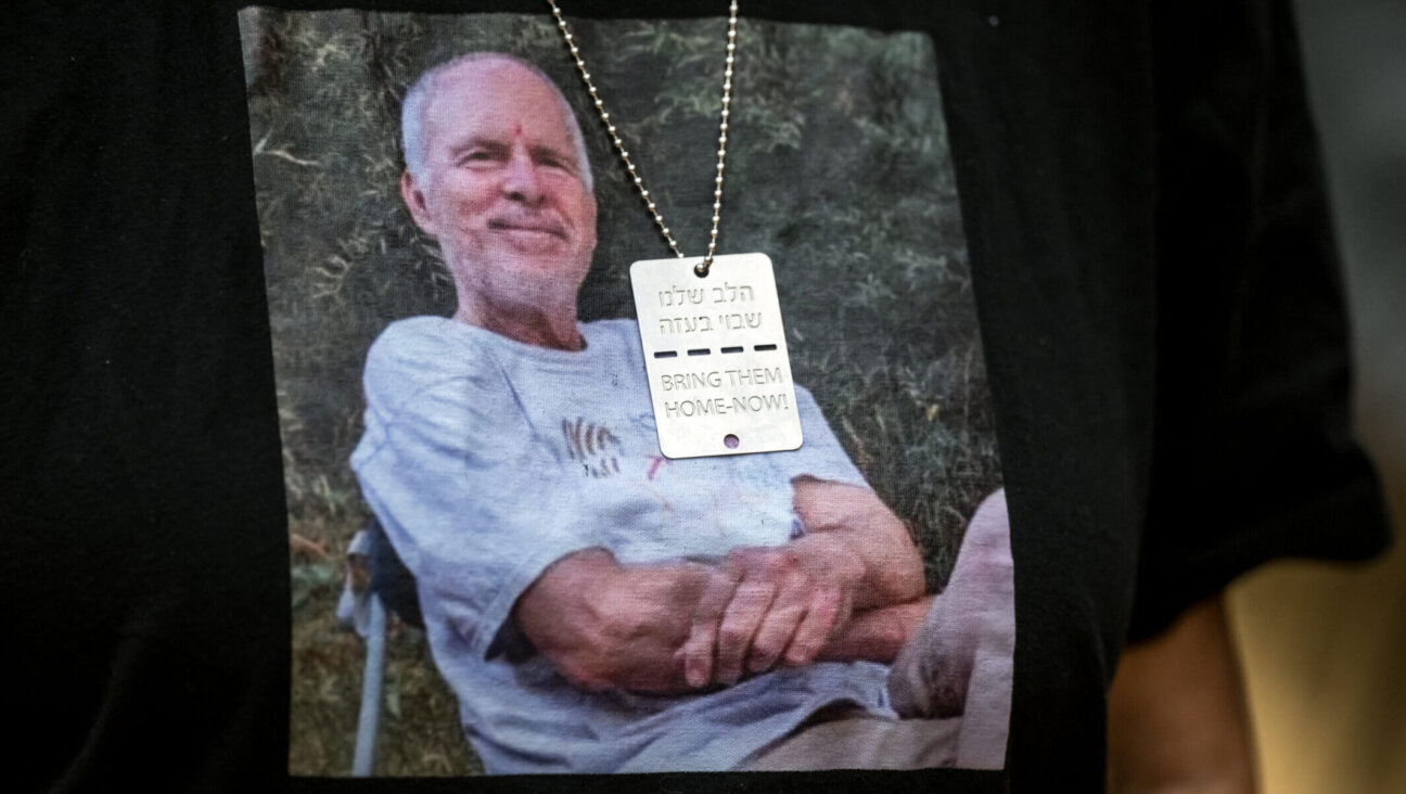 Former Hamas hostage Aviva Siegel poses with a T-shirt showing a picture of her husband Keith Siegel during an interview in Geneva, Feb. 28, 2024. (Fabrice Coffrini / AFP via Getty Images)