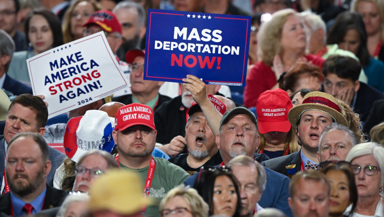 Attendees of last summer's Republican National Convention hold signs calling for mass deportations.