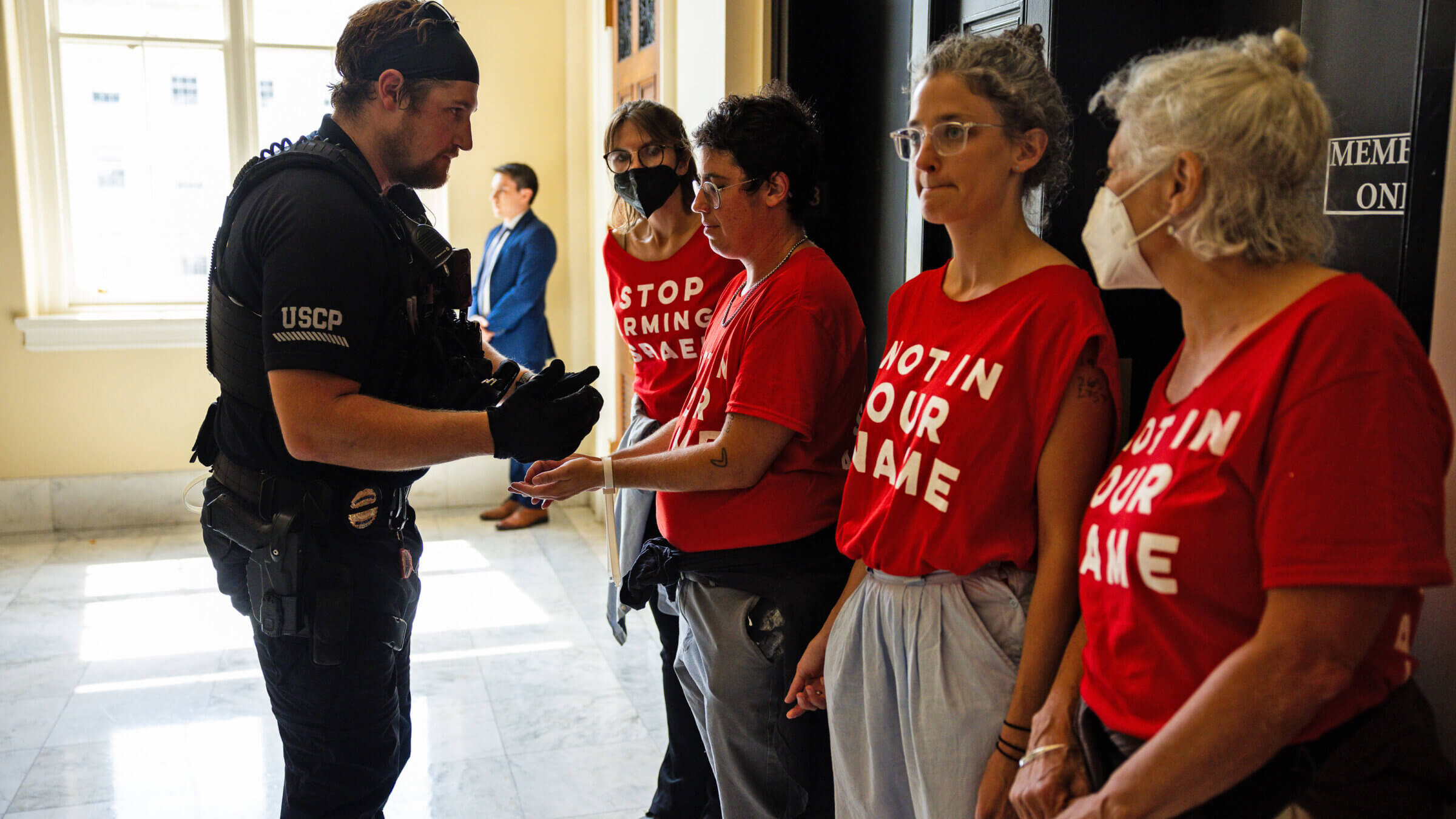 Demonstrators from Jewish Voice For Peace are taken into custody as they protest the war in Gaza at the Cannon House Building in July. The organization recently settled fraud allegations related to their eligibility for pandemic-era relief.