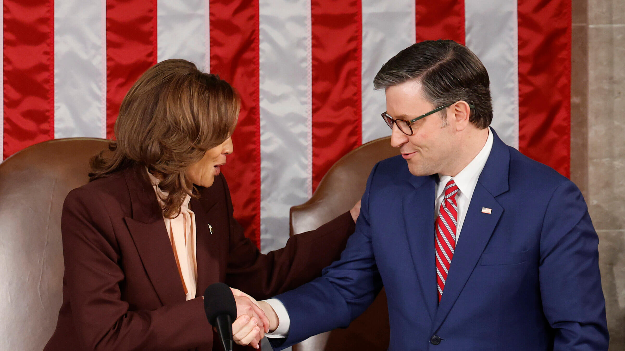 U.S. Vice President Kamala Harris  shakes hands with U.S. Speaker of the House Mike Johnson after Harris certifies the Electoral College vote.