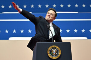 Elon Musk gestures as he speaks during the inaugural parade inside Capitol One Arena