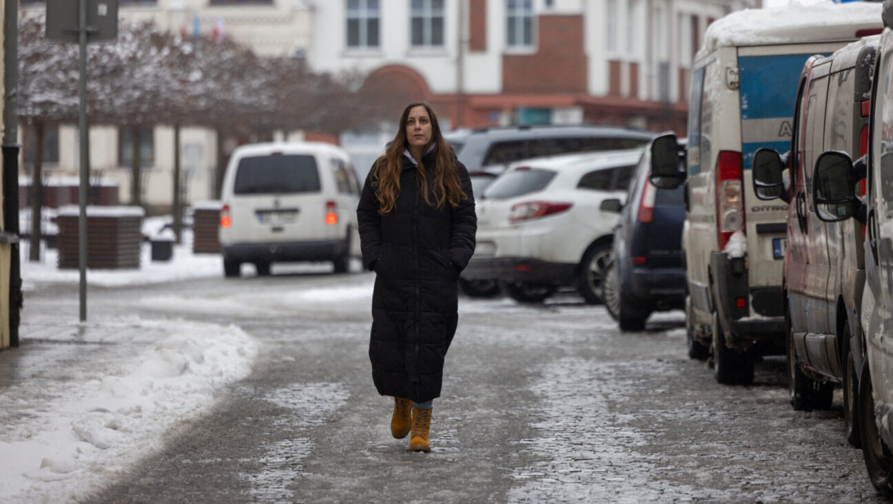 Hila Weisz-Gut, 34, an Israeli researcher in Holocaust studies who relocated to Oswiecim to be with her Polish husband, walks on the street in Oswiecim, Jan. 13, 2025.(Wojtek Radwanski/AFP via Getty Images)