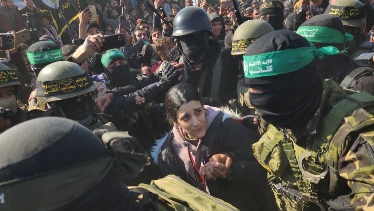 Arbel Yehud, an Israeli hostage held in Gaza, is made to traverse a dense crowd of terrorists before being handed over to the Red Cross outside Yahya Sinwar’s house in Khan Yunis, Gaza, Jan. 30, 2025. (Hani Alshaer/Anadolu via Getty Images)