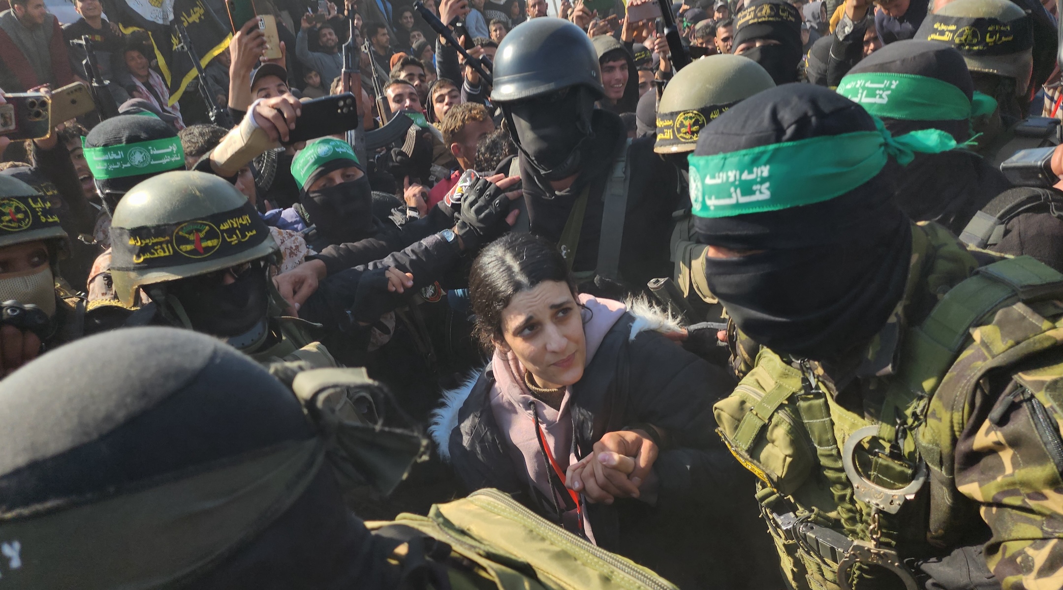 Arbel Yehud, an Israeli hostage held in Gaza, is made to traverse a dense crowd of terrorists before being handed over to the Red Cross outside Yahya Sinwar’s house in Khan Yunis, Gaza, Jan. 30, 2025. (Hani Alshaer/Anadolu via Getty Images)