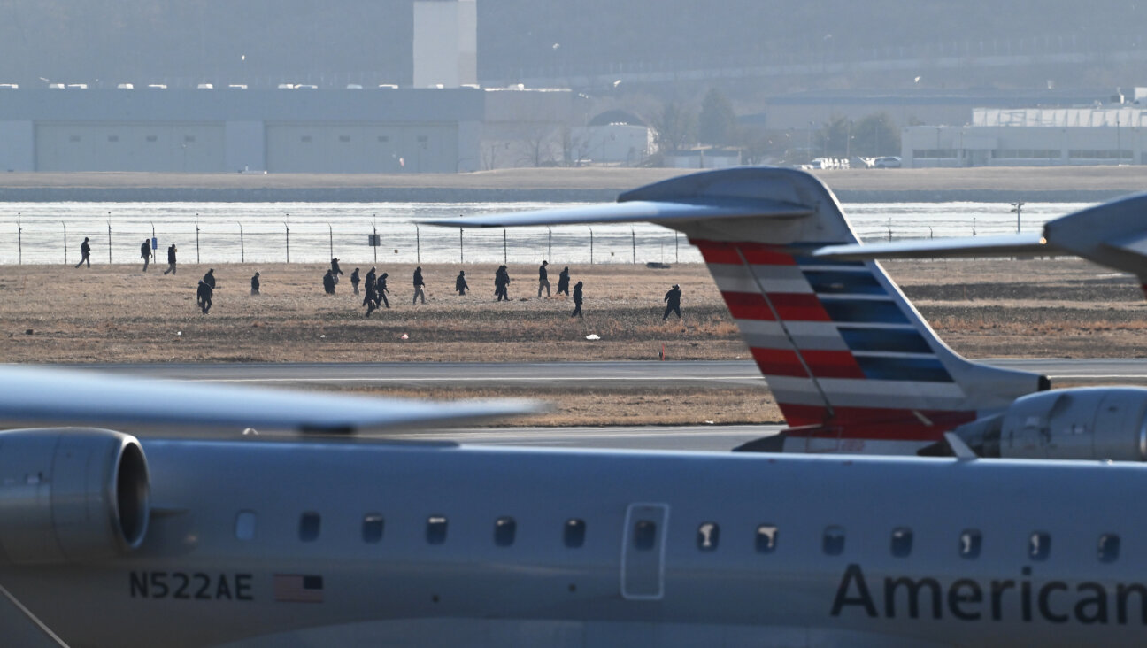 Search personnel fan out and scour an area at Ronald Reagan Washington National Airport on Thursday Jan. 30, 2025 in Arlington, Virginia following Wednesday’s plane crash. (Matt McClain/The Washington Post via Getty Images)