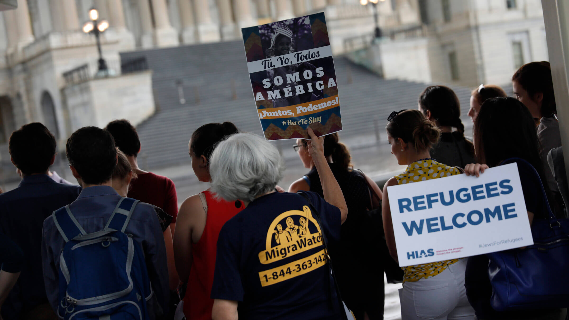 Activists hold signs during a demonstration organized by HIAS outside the U.S. Capitol in 2017. The organization has been forced to make deep cuts to its budget even as it seeks to prepare for a second Trump administration.