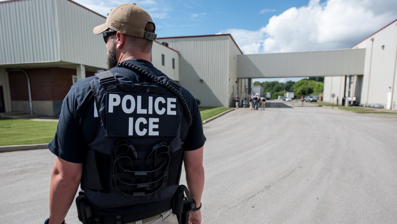 An Immigration and Customs Enforcement special agent prepares to arrest alleged undocumented immigrants in Salem, Mass., June 19, 2018. (Smith Collection/Gado/Getty Images)