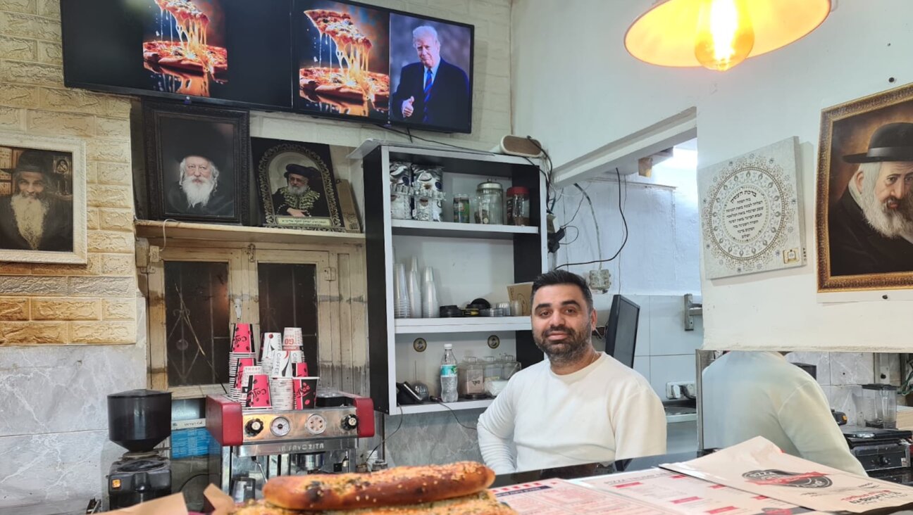 Yitzchak Babayoff, the owner of Pizza Trump in Jerusalem, poses in his shop on Inauguration Day, Jan. 20, 2025. (Deborah Danan)