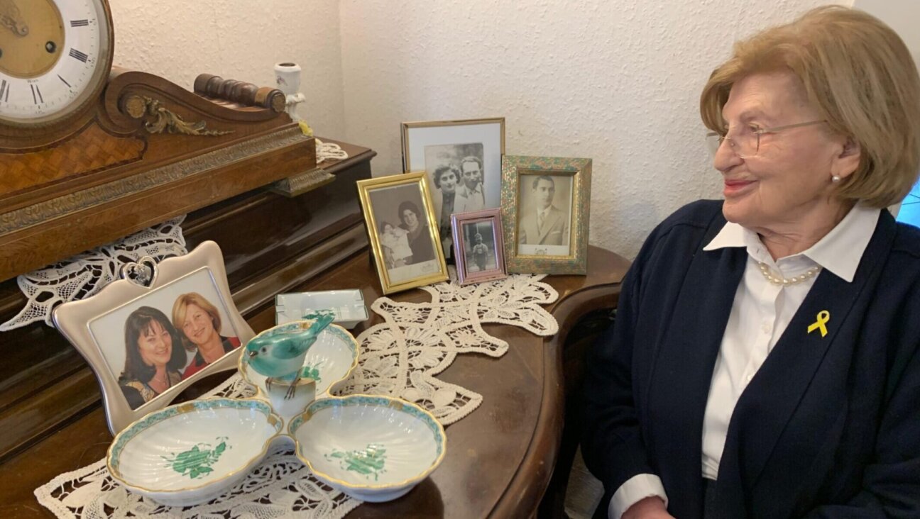 Eva Szepesi, 92, gazes at family photos in her Frankfurt home. Szepesi, 92, is a Holocaust survivor attending the ceremony marking the 80th anniversary of the liberation of Auschwitz.