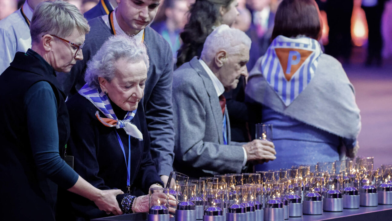 Holocaust survivor Nusia Horowitz, second from the left, lights a candle on Jan. 27, during the commemoration of the 80th anniversary of the liberation of the Nazi concentration and extermination camp Auschwitz-Birkenau by the Red Army.