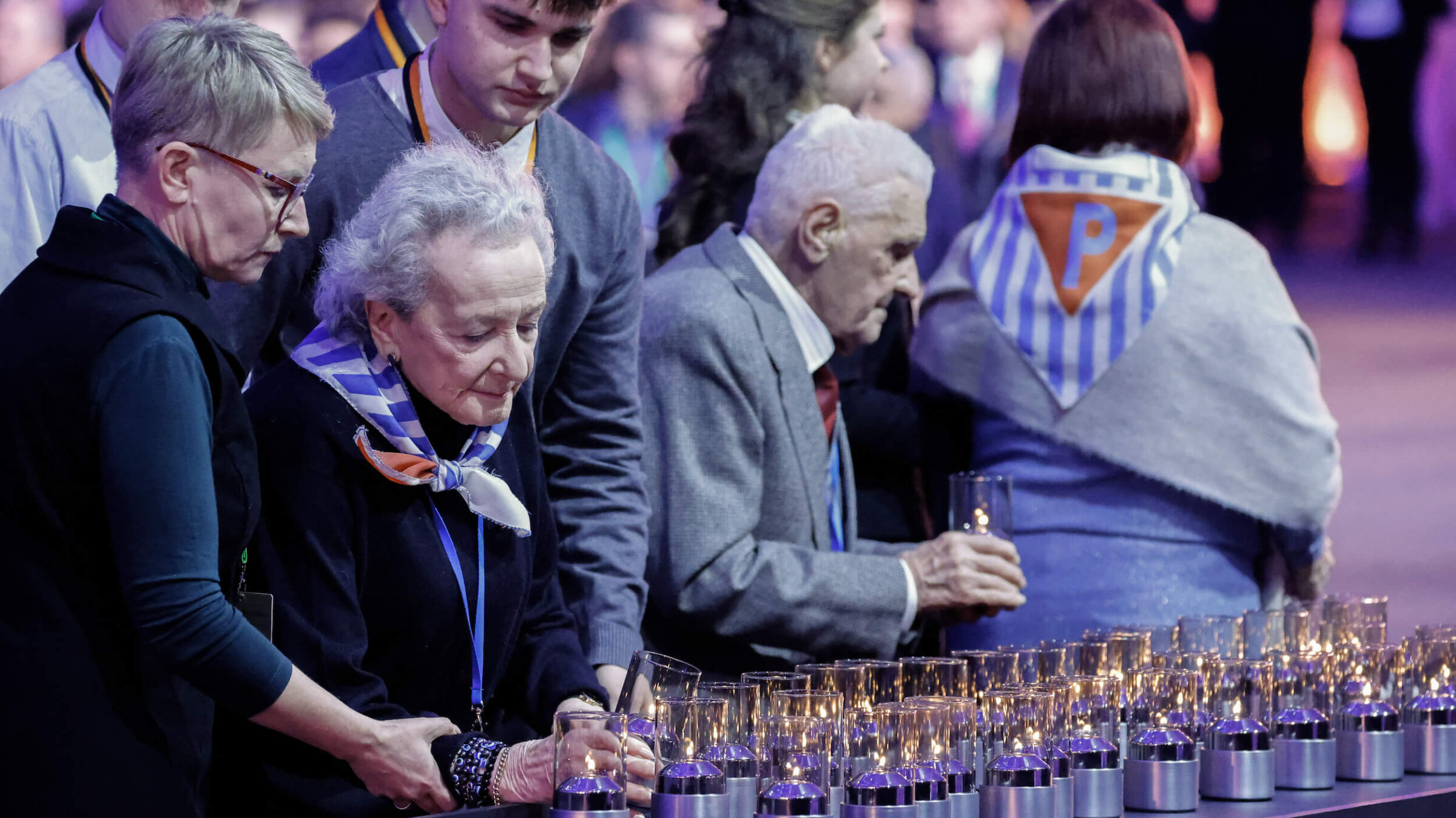 Holocaust survivor Nusia Horowitz, second from the left, lights a candle on Jan. 27, during the commemoration of the 80th anniversary of the liberation of the Nazi concentration and extermination camp Auschwitz-Birkenau by the Red Army.