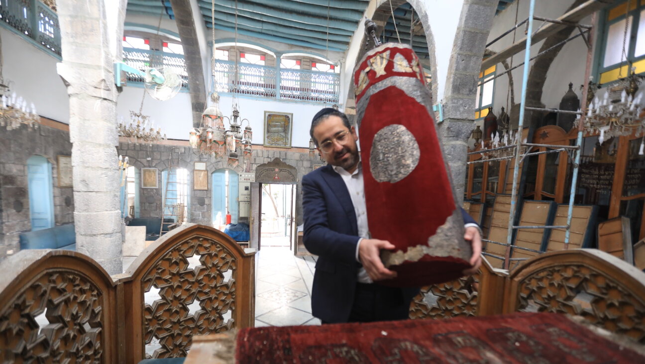 Syrian Rabbi Yousef Hamra and accompanying Jews visit the Frenc and Raki churches, the Maimonides Jewish School and the Jobar Synagogue, which was largely destroyed during the civil war, in the historic districts of Damascus, Syria on February 18, 2025. Yousef Hamra, who was forcibly migrated from Syria in 1992, arrived in the Syrian capital Damascus after 33 years. (Bakr Al Kasem/Anadolu via Getty Images)