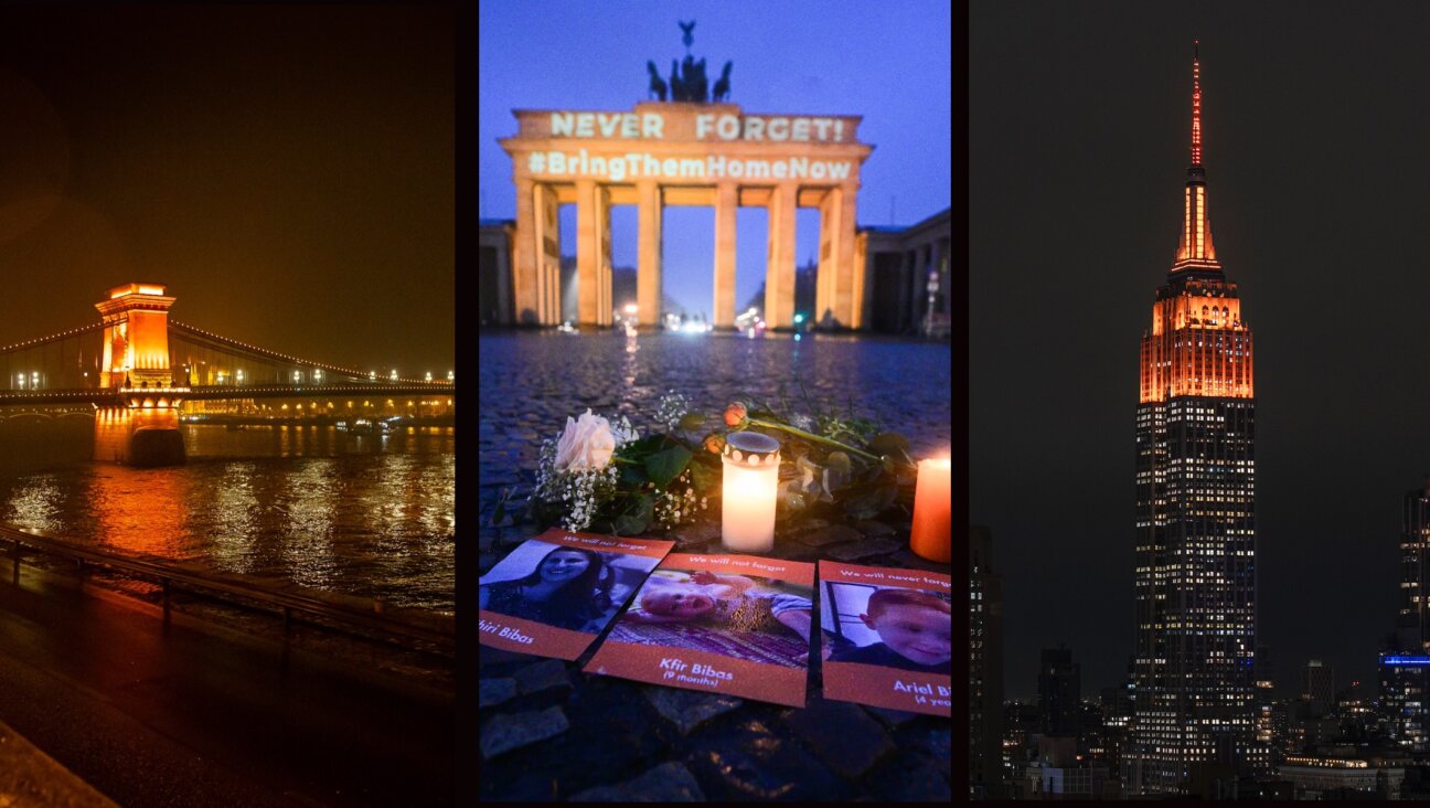 L-R: Budapest’s Chain Bridge; Berlin’s Brandenburg Gate; and New York City’s Empire State Building are illuminated in orange to honor the slain Bibas family, Feb. 26, 2025. (Courtesy Kidma; Sebastian Gollnow/picture alliance via Getty Images; Craig T Fruchtman/Getty Images)