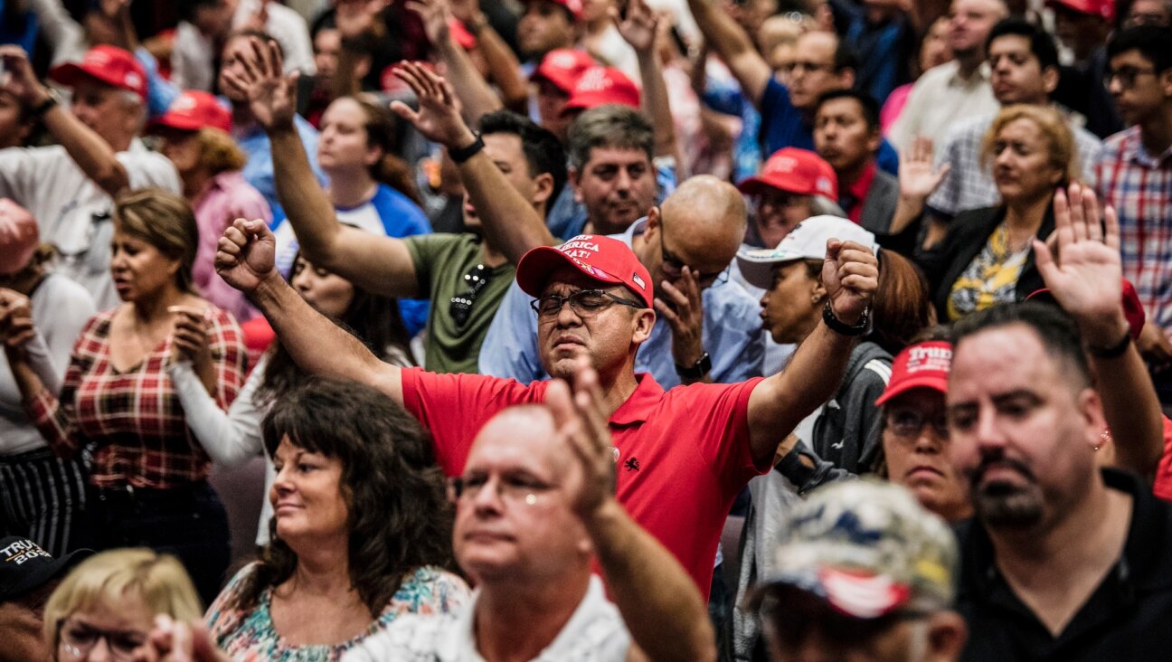 Attendees pray before President Donald Trump addresses the crowd at the King Jesus International Ministry during a “Evangelicals for Trump” rally in Miami, Florida, Jan. 3, 2020. (Scott McIntyre/For The Washington Post via Getty Images)