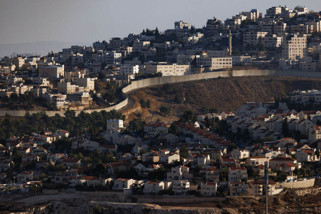 The village of Al-Ram and an Israeli settlement in the occupied West Bank separated by a wall on Nov. 4, 2023. 