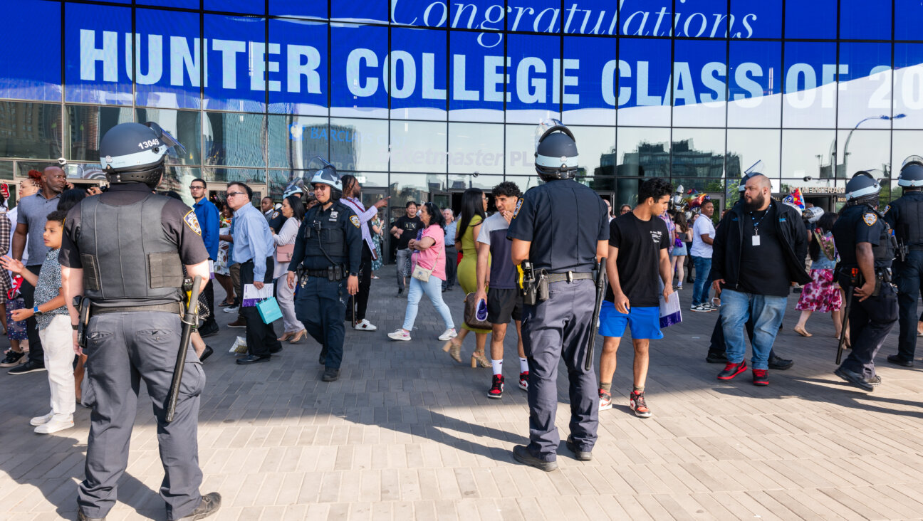 Police keep watch as pro-Palestinian demonstrators hold a small protest outside of graduation ceremonies for Hunter College in June 2024.