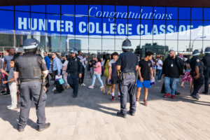 Police keep watch as pro-Palestinian demonstrators hold a small protest outside of graduation ceremonies for Hunter College in June 2024.