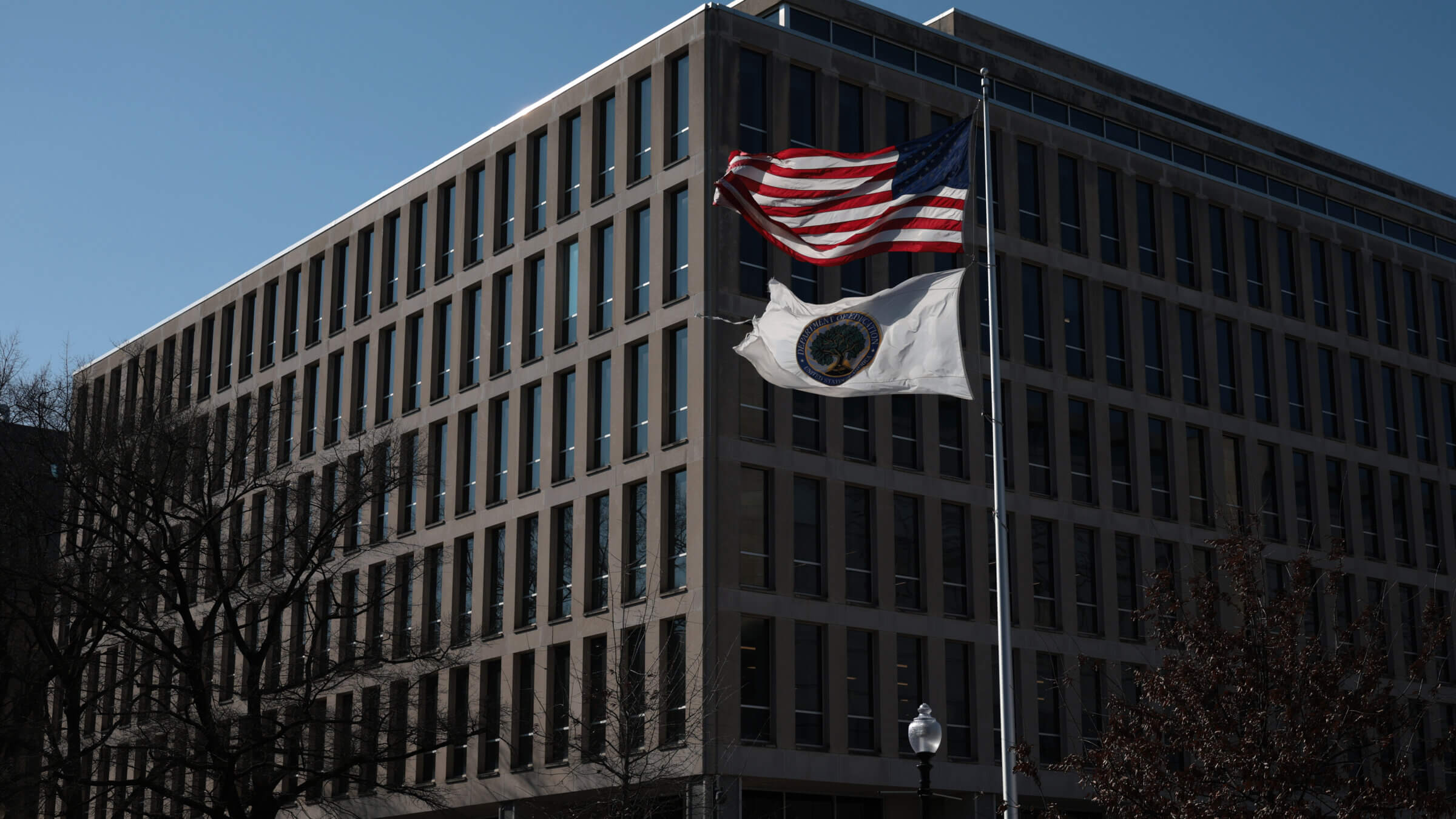 A U.S. flag and an Education Department flag fly outside the building of the U.S. Department of Education on Tuesday. It’s been reported that President Donald Trump is prepared to issue an executive order minimizing the department's functions.